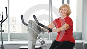 Active and healthy senility. A beautiful senior woman in red t-shirt going in for sports. Active life in old age