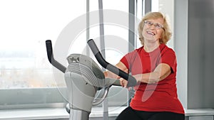 Active and healthy senility. A beautiful senior woman in red t-shirt going in for sports. Active life in old age