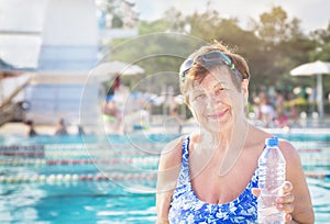 Active healthy senior woman (over the age of 50) in sport goggles and bottle of water