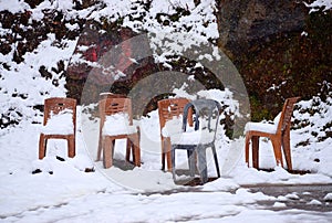 Active Heavy Snowfall - Thick Layer of Snow on Ground and Chairs - Extreme Cold Weather - Abstract