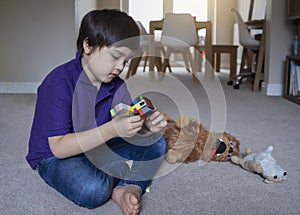 Active kid playing with construction plastic toy blocks, Child boy playing colorful toys in playroom at home, Toddler development