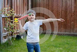 Active kid preparing to throwing a Javelin, Healhty Child practicing athletics throw Javelin. Outdoor activity for Children on