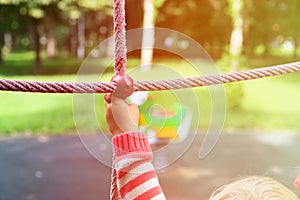 Active kids sport and playtime - hand of child climbing at playground