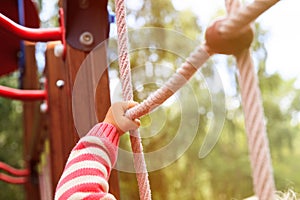 Active kids sport and playtime - hand of child climbing at playground