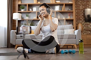 Active lady recording workout video for sport vlog via phone