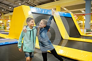 Active leisure. Children having fun on trampoline in entertainment center, childhood and sporty lifestyle. Boy and girl in leisure