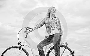 Active leisure and healthy activity. Girl ride cruiser model bicycle. Woman rides bicycle sky background. Healthiest