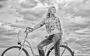 Active leisure and healthy activity. Girl ride cruiser model bicycle. Woman rides bicycle sky background. Healthiest