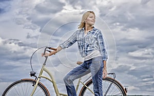 Active leisure and healthy activity. Girl ride cruiser model bicycle. Woman rides bicycle sky background. Healthiest