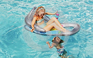 Active lifestyle. Boy with mother at aquapark. Swim in swimming pool. Family summer vacation. Pool party.