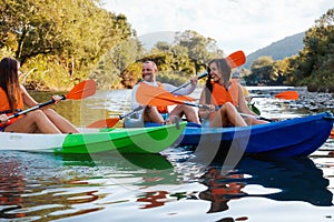 Active lifestyle. A group of happy young people are kayaking at th river. World Tourism Day concept