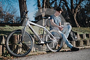 Active lifestyle moment with a man and his bicycle in a sunny park