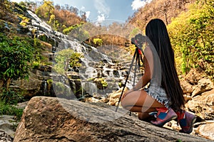 Active lifestyle travel photographer make photo Mae Ya Waterfall is one of the most beautiful cascades in Doi Inthanon, Chiang Mai