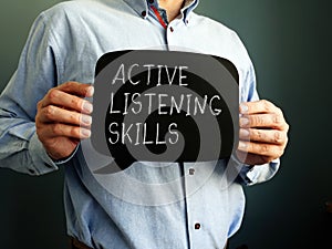 Active Listening Skills handwritten sign on the blackboard. photo