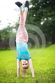 Active little girl turning outdoors, sport and children