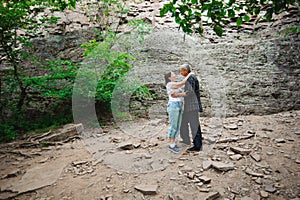 Active loving senior couple walking in beautiful summer forest - active retirement concept.