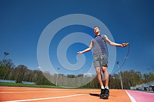 Active male athlete skipping the rope outside