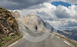 Active male tourist enjoys a scenic bicycle trip along the great alpine route.