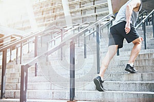 Active man climbing up the stairs in a sportswear