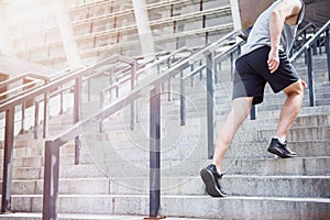 Active man climbing up the stairs in a sportswear