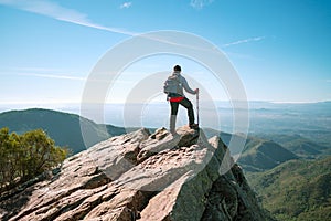 Active man looking at the landscape. Real person. Rocky landscape. photo