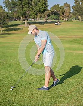 active man playing golf game on green grass, summer