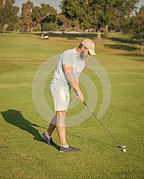 active man playing golf game on green grass, summer