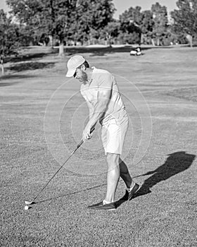 active man playing golf game on green grass, summer