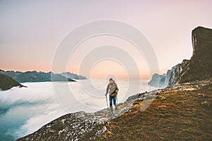 Active man trail running in sunset mountains with backpack