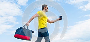 Active man traveler traveling with travel bag sky background, travel