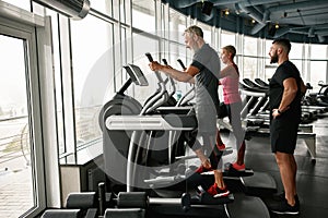 Active mature couple exercising together at gym