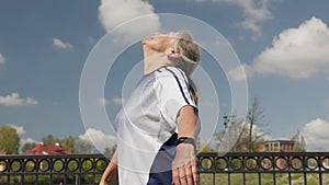 active mature senior woman doing sports, cool down, take deep breath, hands up