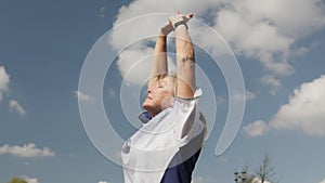 active mature senior woman doing sports, cool down, take deep breath, hands up