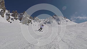 Active Mature Skier Skiing Down From The Mountain Slopes In Winter On Alpine Ski