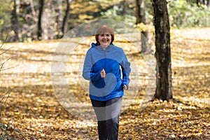 Active middle-aged woman  jogs runs