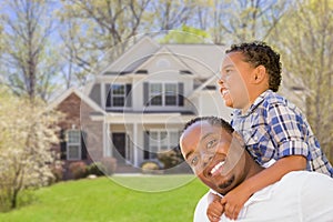 Active Mixed Race Father and Son In Front of House