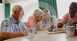 Active mixed-race senior people playing chess game in the nursing home 4k
