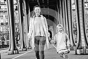 Active mother and child on Pont de Bir-Hakeim bridge walking