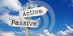 Active, passive - wooden signpost with two arrows