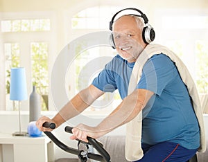 Active pensioner doing spinning with music photo