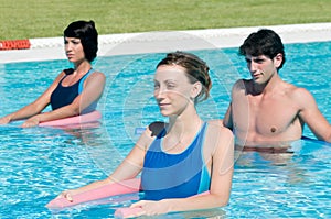 Active people doing aqua gym in a pool