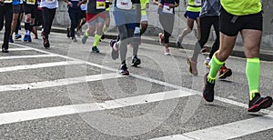 Active people running,marathon runners on the city road, detail of legs