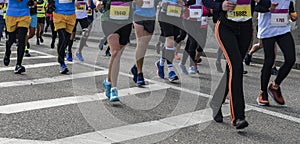 Active people running,marathon runners on the city road, detail of legs