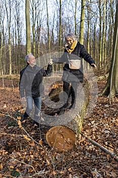 Active, playful senior couple in autumn forest