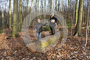 Active, playful senior couple in autumn forest