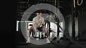 Active powerful muscular fitness instructor Caucasian man sportsman athlete bodybuilder training with battle ropes