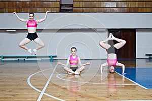 Active pretty girl in action jumping in the air, girl standing upside down, girl stand on hands, sport young woman sitting on the