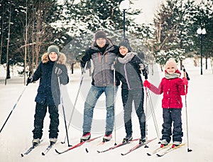 Active rest. Family skiing in the winter forest