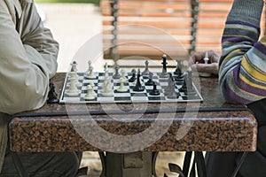 Active retired people, old friends and free time, two seniors having fun and playing chess game at park. Old men are playing chess