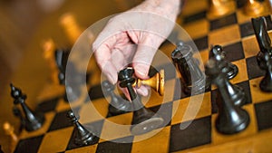 Active retired persons, hand of old woman holding chess piece